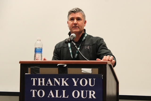 PSBCA coach speaking at a podium
